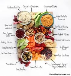 a platter filled with different types of food including crackers, dips and vegetables