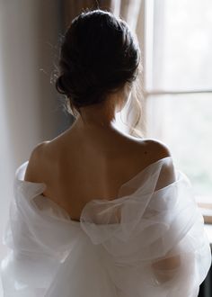 the back of a woman's dress in front of a window