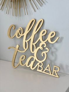 a coffee and tea bar sign sitting on top of a table