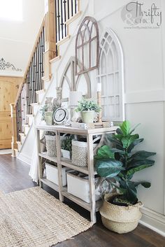 an entryway with plants and baskets on the floor