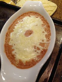 a white bowl filled with food sitting on top of a stove