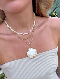 Our Shell Yeah Gold Filled Necklace is the perfect necklace for the beach lover. This necklace features 24k Gold Filled chain, real sea shell with gold plated edges, and lightweight for layering. Style this necklace with your favorite summer dress, your next beach trip with your fave bikini, or with your fave graphic tee! Please be gentle with your shell ♡ All accessories are final sale. Cheap Casual Strand Shell Necklace, Cheap Beachy Shell Necklace, Cheap Shell Necklaces For Vacation, Luxury Shell Necklaces For The Beach, Affordable Beachy Shell Necklace, Real Shell Necklace, Beach Necklace Stack, Living Mood Board, Necklace Stacks