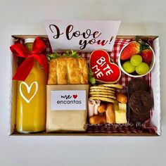 a box filled with different types of food and fruit next to a sign that says i love you