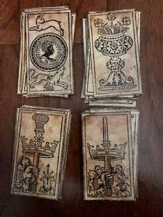 four cards with designs on them sitting on a table