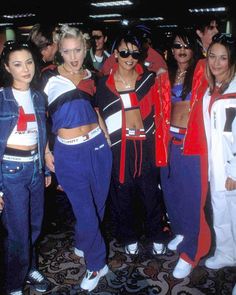 several women in matching outfits posing for the camera