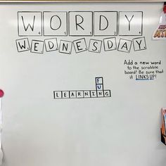 a whiteboard with words spelling wordly wednesday written on it in front of a class room bulletin board