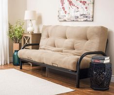 a living room with a futon and rug