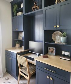 a home office with blue cabinets and desk