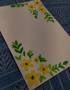 a piece of paper with yellow flowers painted on it