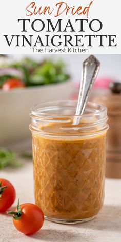 sun dried tomato vinaigrette in a glass jar with a spoon on the side