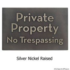 a metal sign that says private property no trespassing silver nickel raised