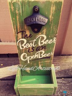 the best beer is an open beer sign on a wooden bench with words painted on it