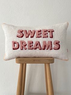 a pillow that says sweet dreams on the front, and red lettering on the back