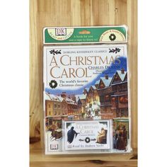 a christmas carol cd case sitting on top of a wooden shelf