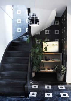 a black and white staircase with plants on it