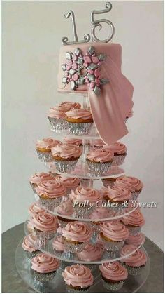 a tiered cupcake cake with pink frosting