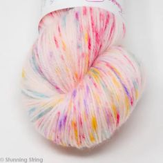 a skein of yarn with multicolored stripes on it and a white background