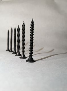 several black screws are lined up in a row