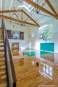 an indoor basketball court with hard wood floors