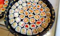 there are many sushi rolls in the pan on the stove top, ready to be eaten