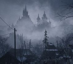 an old castle in the fog with trees and houses around it on a dark, gloomy day