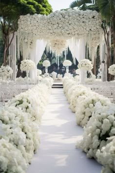 the aisle is lined with white flowers and draped in draping for an outdoor ceremony