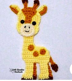 a crocheted giraffe is shown in yellow and brown with black eyes