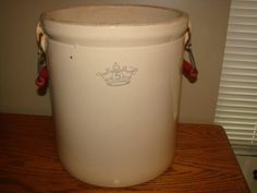 a white bucket sitting on top of a wooden table