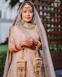 a woman wearing a bridal outfit and jewelry