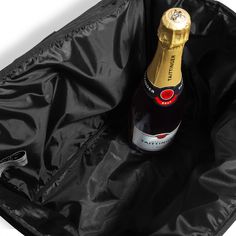 a bottle of champagne sitting in an open black bag on a white surface with the lid closed