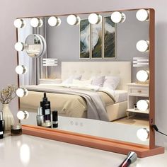 a mirror that is sitting on top of a table next to a lamp and bottles