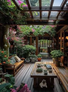 an outdoor patio with potted plants and wooden benches in the center, surrounded by greenery