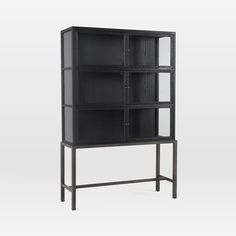 a black bookcase with glass doors on the front and bottom shelves, against a white background