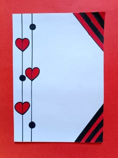 a piece of paper with hearts hanging from it