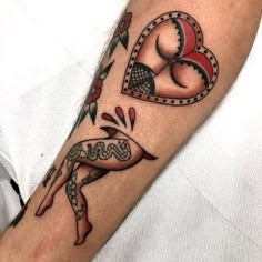 a tattoo on the arm of a man with a heart and arrow in his hand