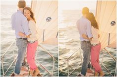 a man and woman hugging on the back of a sailboat in the ocean at sunset