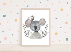 a framed print with a koala bear wearing a crown on it's head