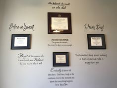 a wall with framed pictures and plaques on it's sides that say different things