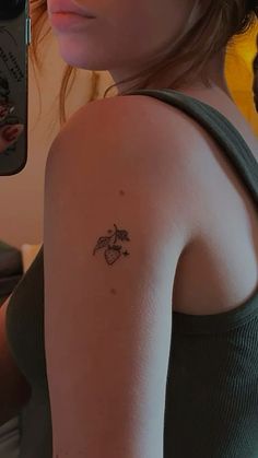 a woman with a small tattoo on her arm