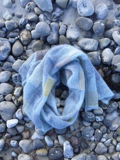 a blue scarf laying on top of some rocks