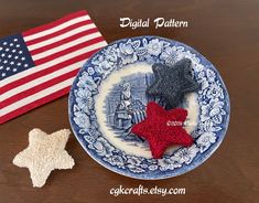 a plate with two small stars on it next to an american flag and a patriotic trinket