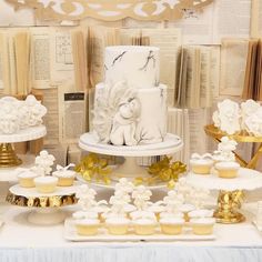 a table topped with lots of cupcakes and cakes