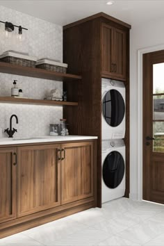 a washer and dryer sitting in a kitchen next to wooden cabinets with open doors