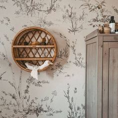 a wall mounted shelf in the corner of a room next to a cabinet and cupboard