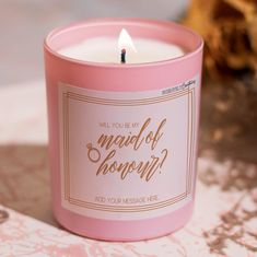 a pink candle with the words, will you be my maid of honin?