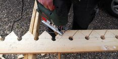 a person using a power tool to cut wood planks with a circular sawhorse