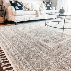 a living room filled with furniture and a rug