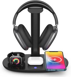 an image of headphones and other electronics on a table with a phone in the background