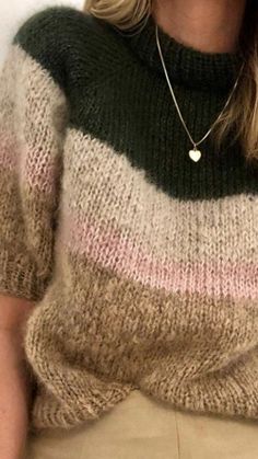 a woman with blonde hair wearing a striped sweater