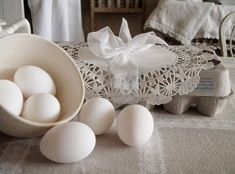 some eggs are sitting on a table next to an egg carton and other items